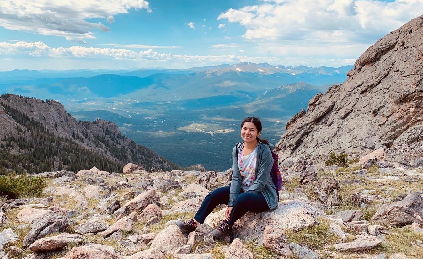 photo of Melody Zarria Samanamud sitting on a rock