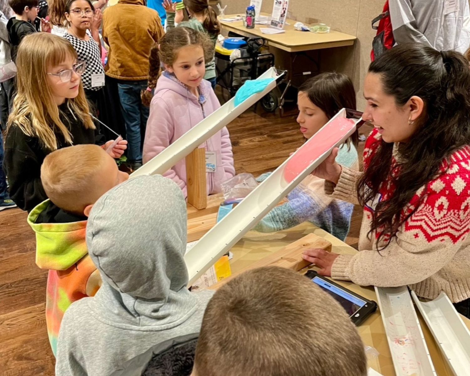 students observe a science experiment with flubber