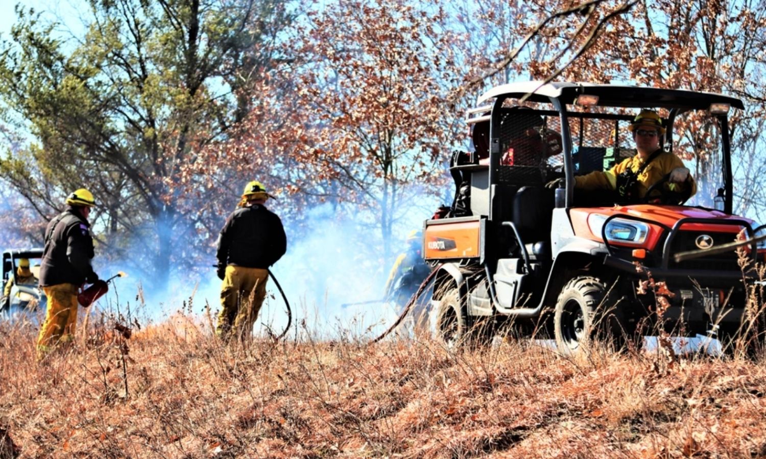 people watching a controlled burn 