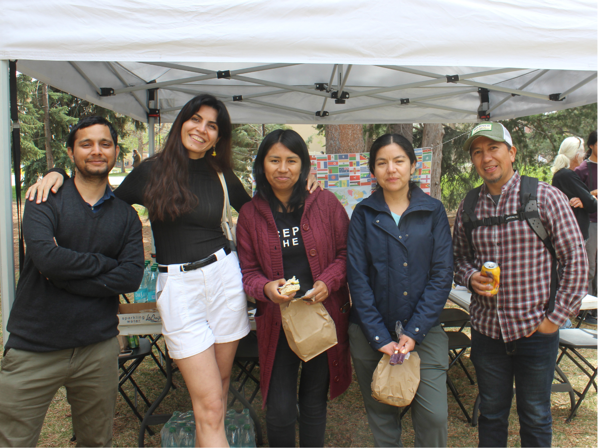 photo of five students posing for a picture at the picnic