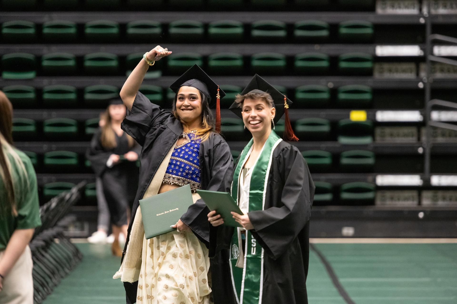 Two students excited at graduation ceremony