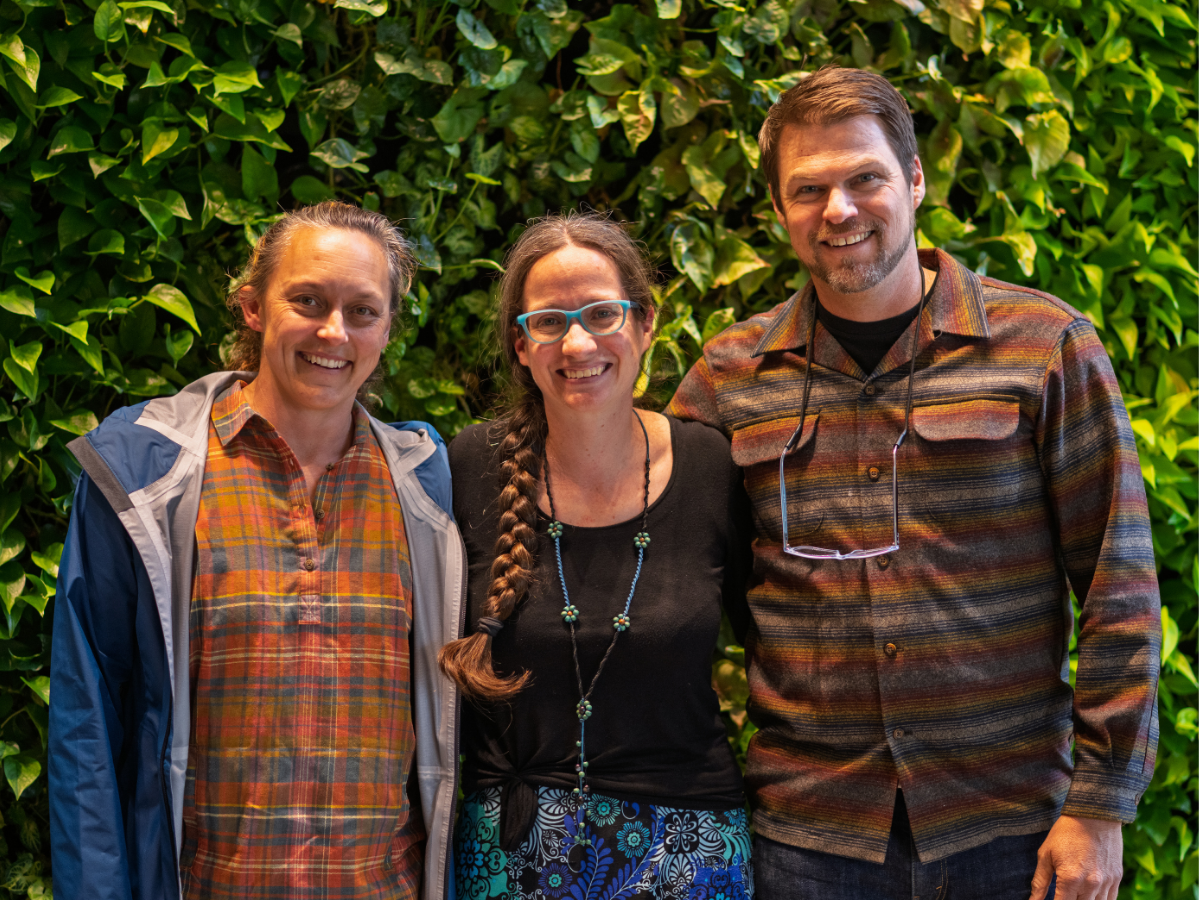 Three award winners pose for a picture at the end-of-year celebration.