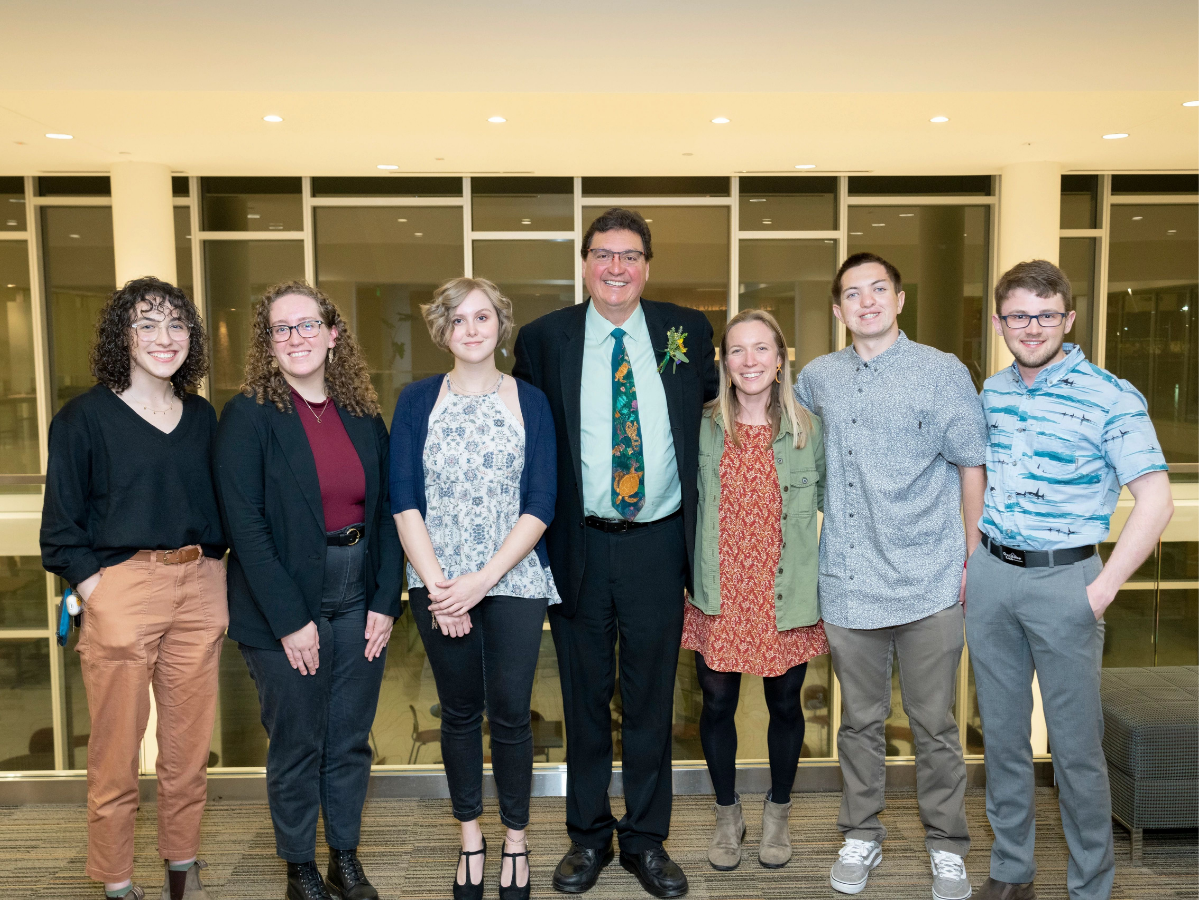 Dean A. Alonso Aguirre, center, stands with students at the recognition dinner. 