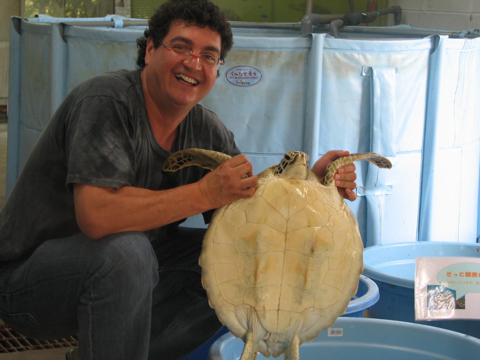 A. Alonso Aguirre holds a turtle.