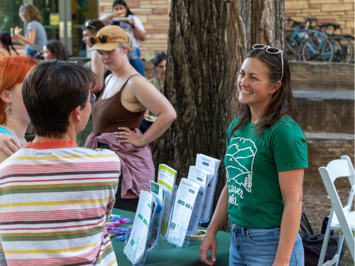 photo of two people talking at a tabling event