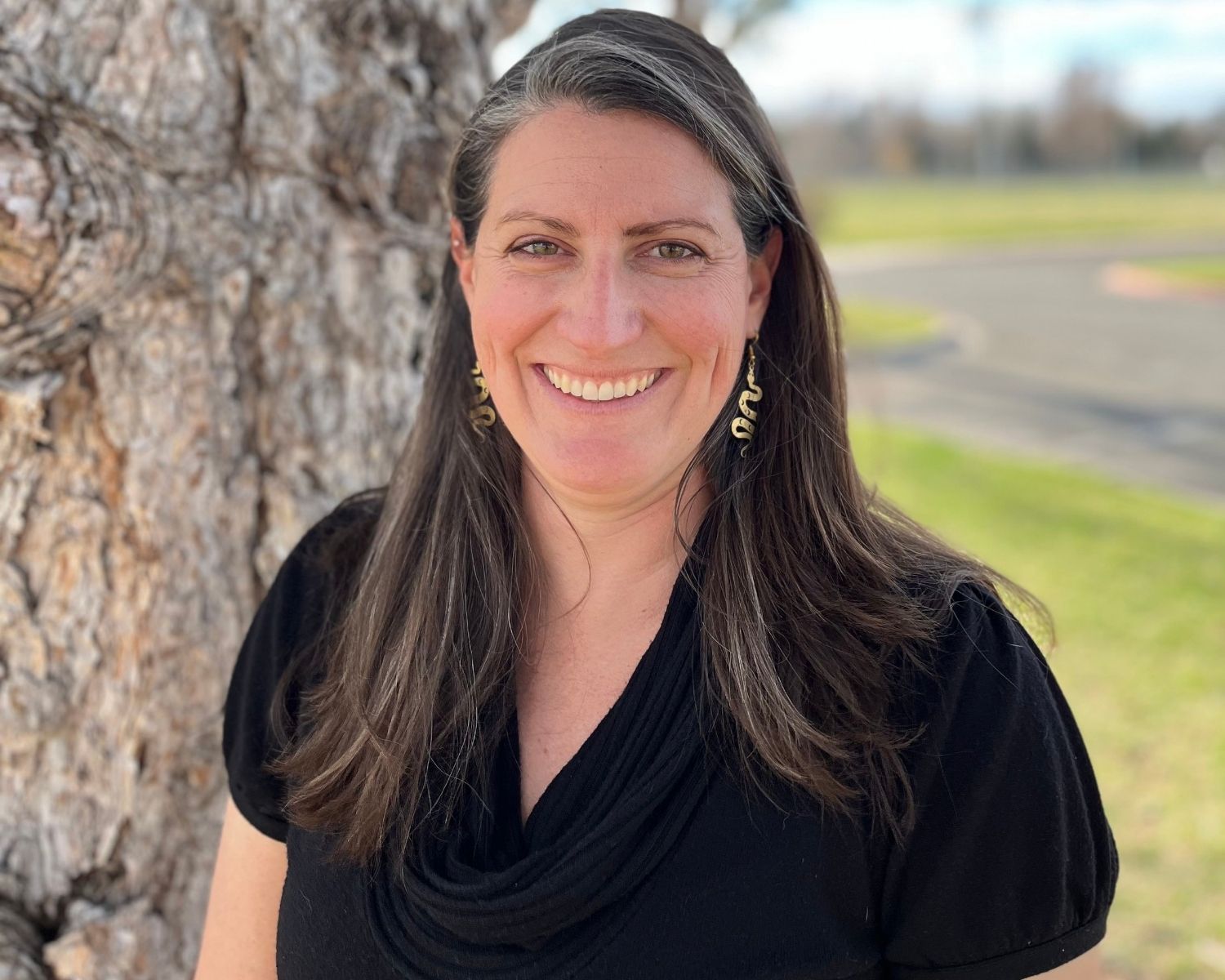 photo of Christina Welch standing in front of a tree