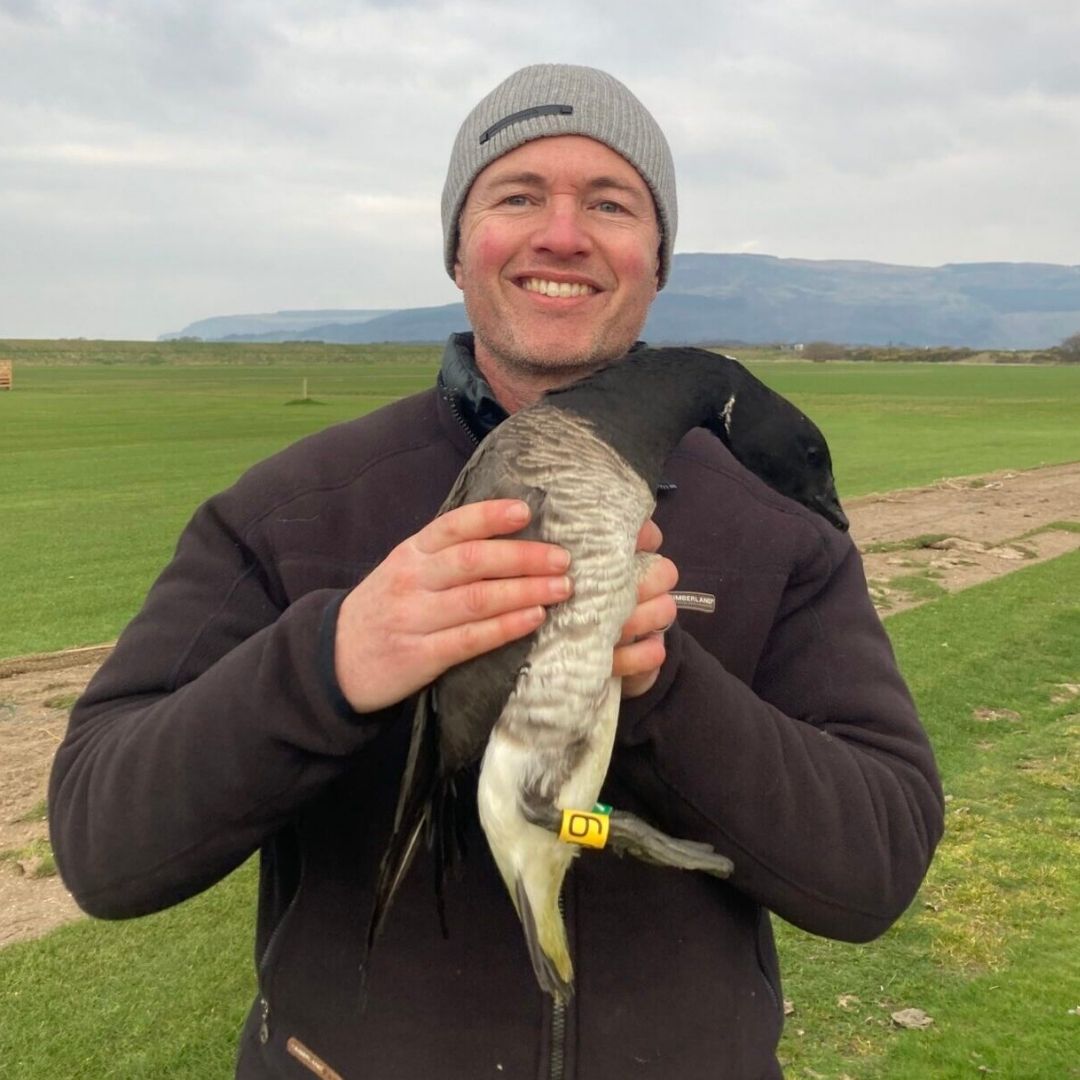 photo of David Koons holding a goose