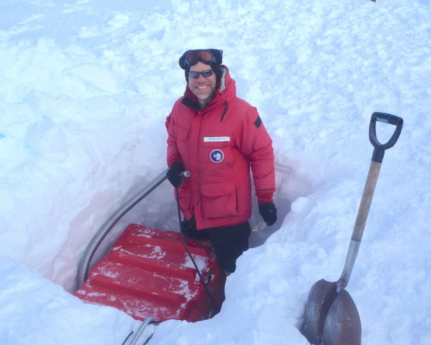 Rick Aster stands in snow while installing a seismograph