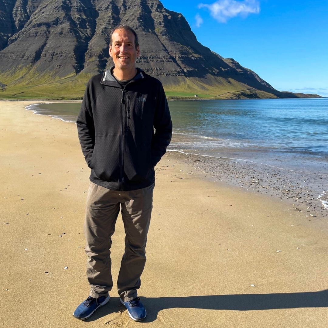 photo of Derek Schutt on a beach