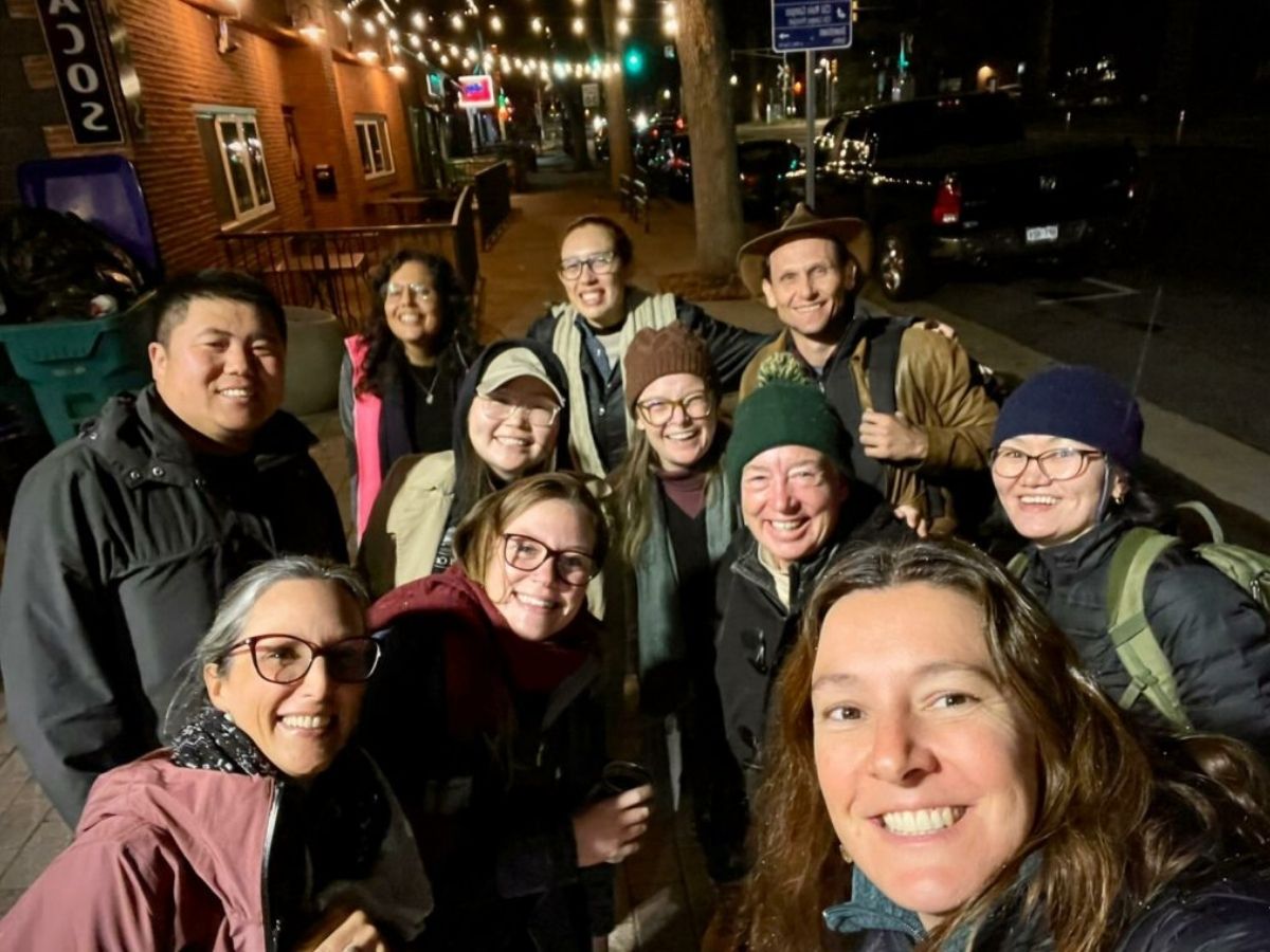 photo of 11 people from a previous cohort smiling
