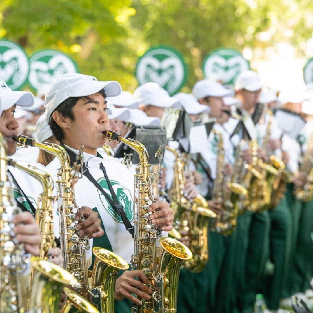The CSU marching band plays their instruments. 