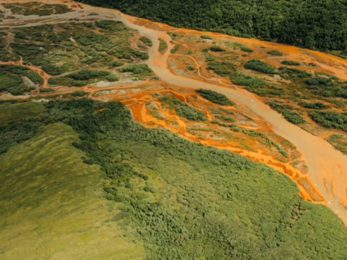 Photo of a river in Alaska that has turned orange. 