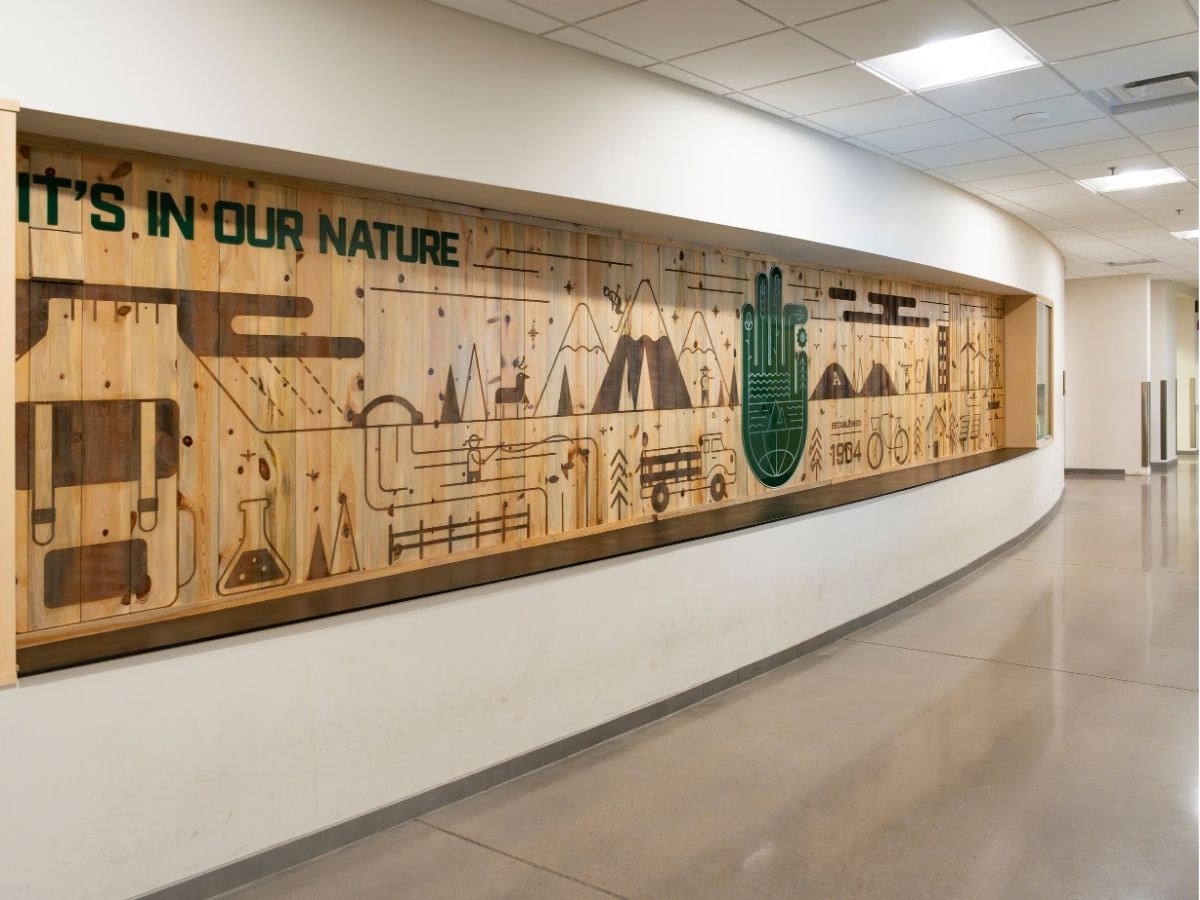 A wooden wall with the Warner hand. 