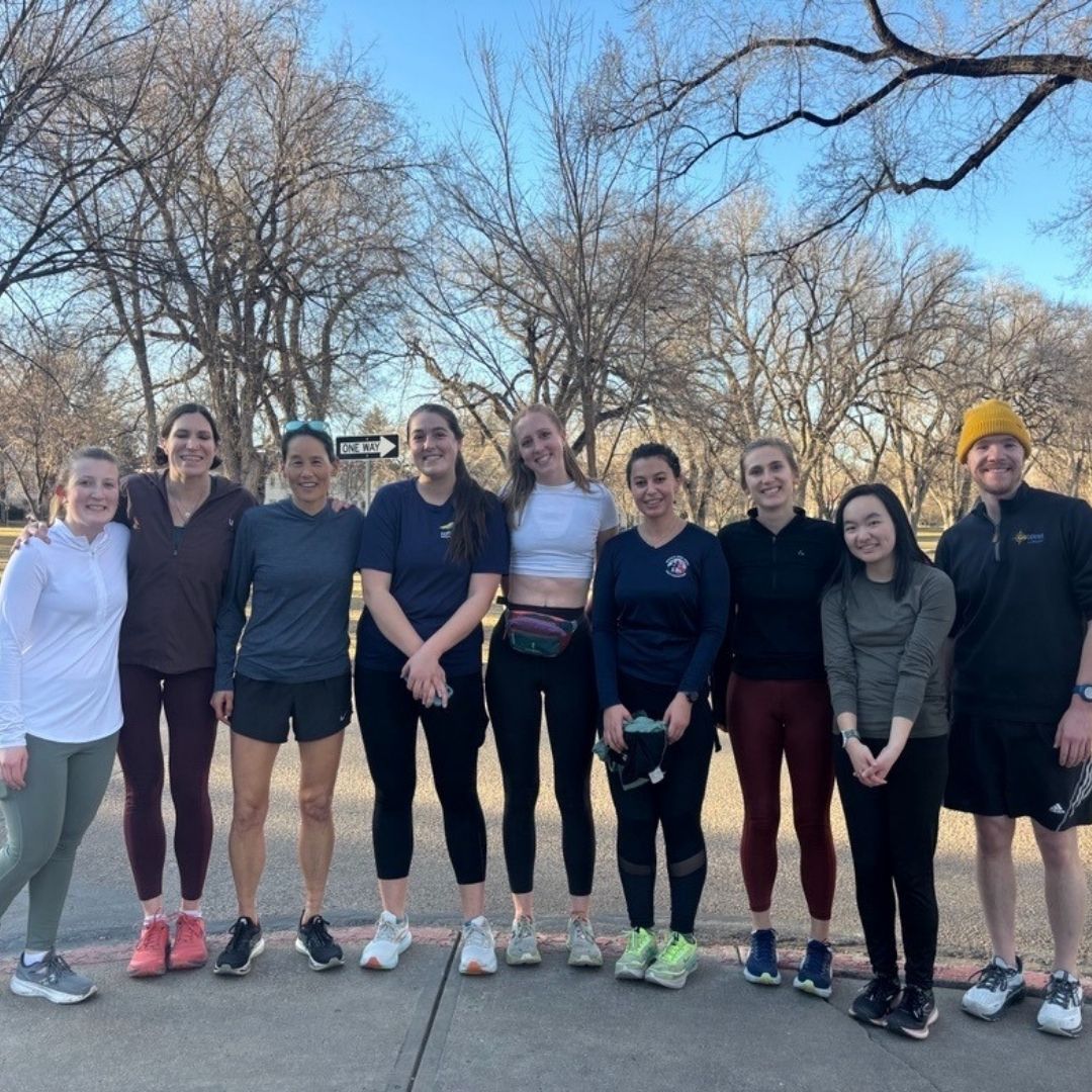 A group of graduate students pose for a picture after a run.