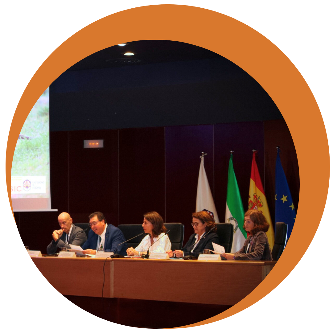 five people seated and talking, including Dean A. Alonso Aguirre