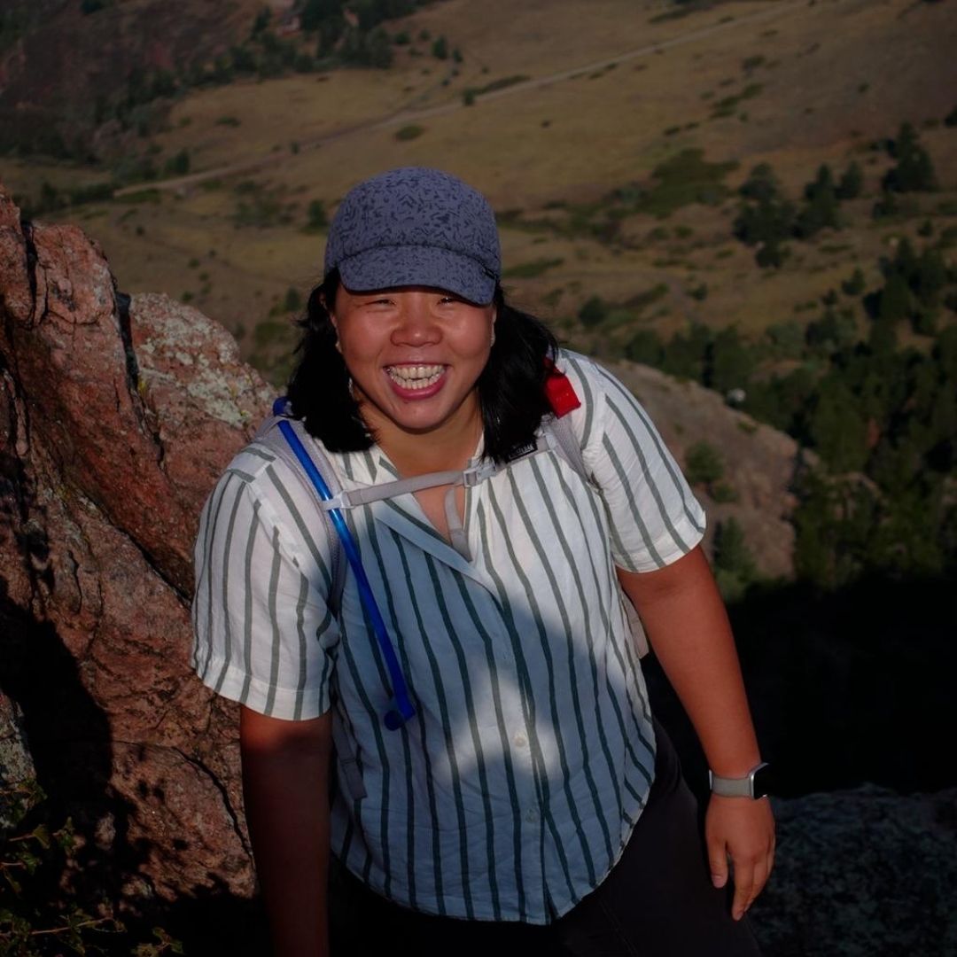 Tian Guo smiles for the camera while hiking. 