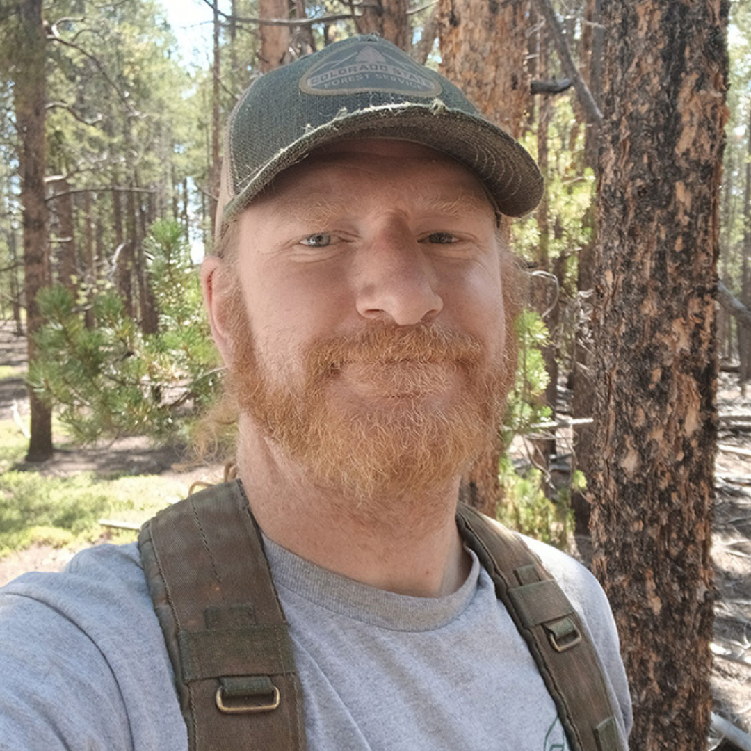 photo of Peter Albrecht with pine trees in the background