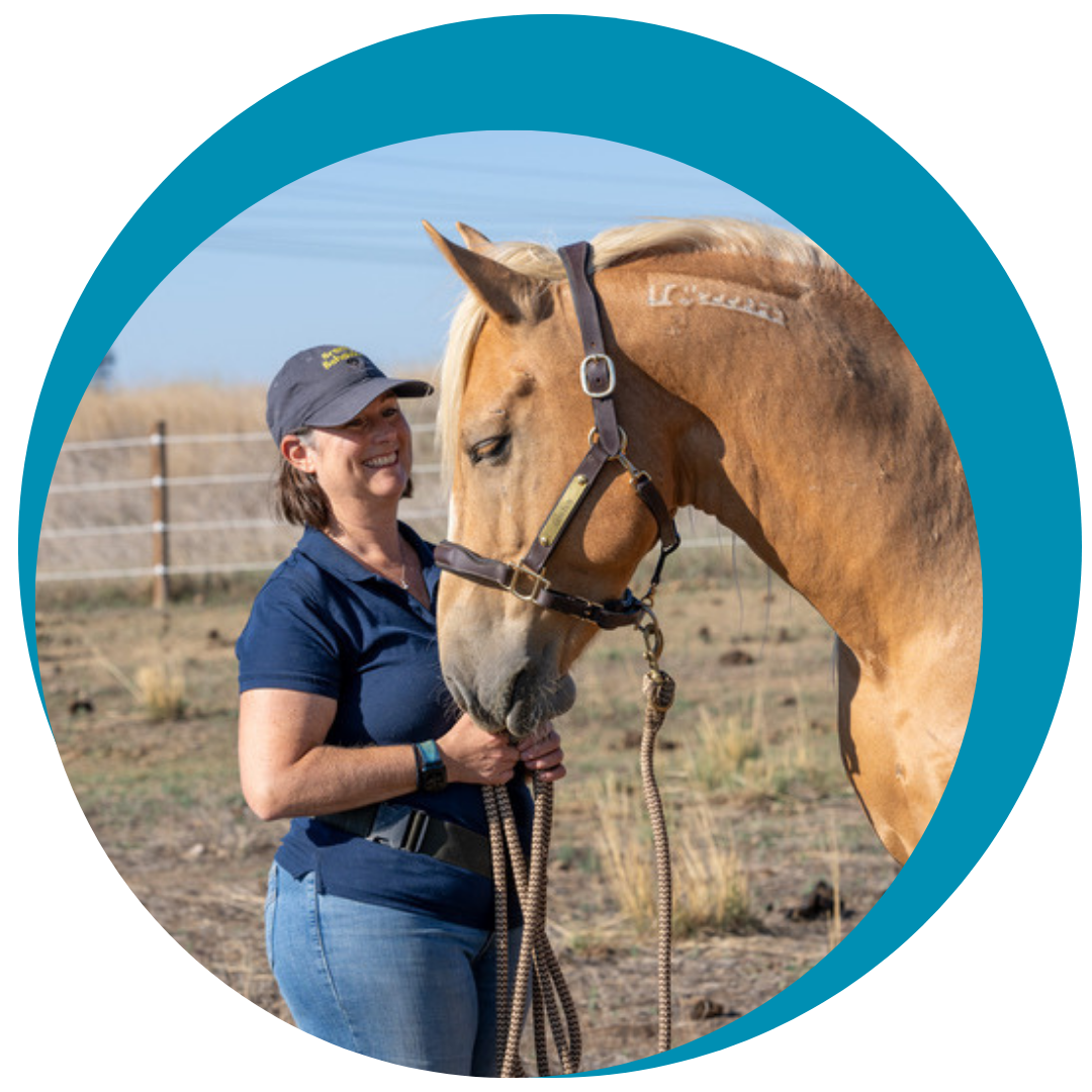 Sarah Buckley King stands with a horse