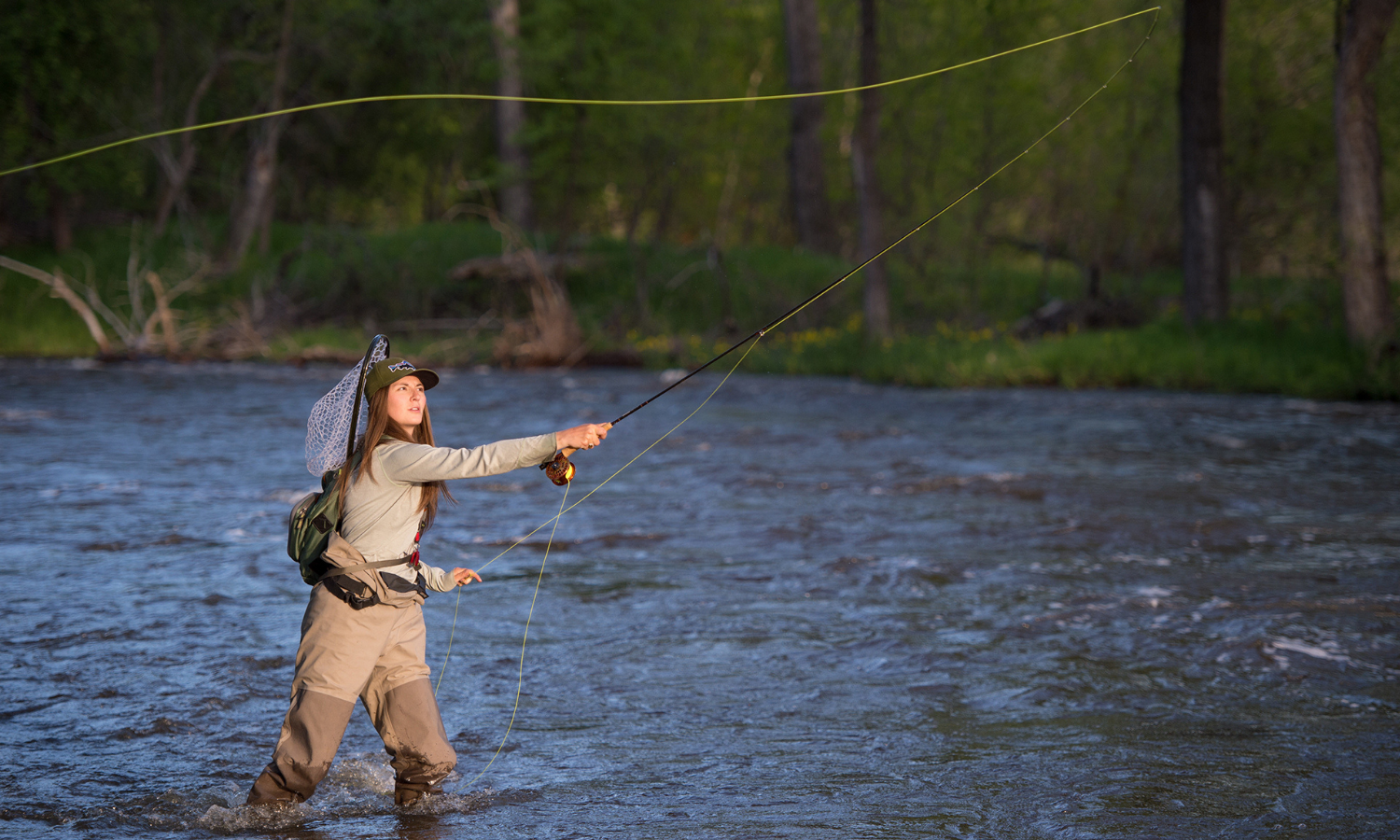 photo of a person fly fishing in a river
