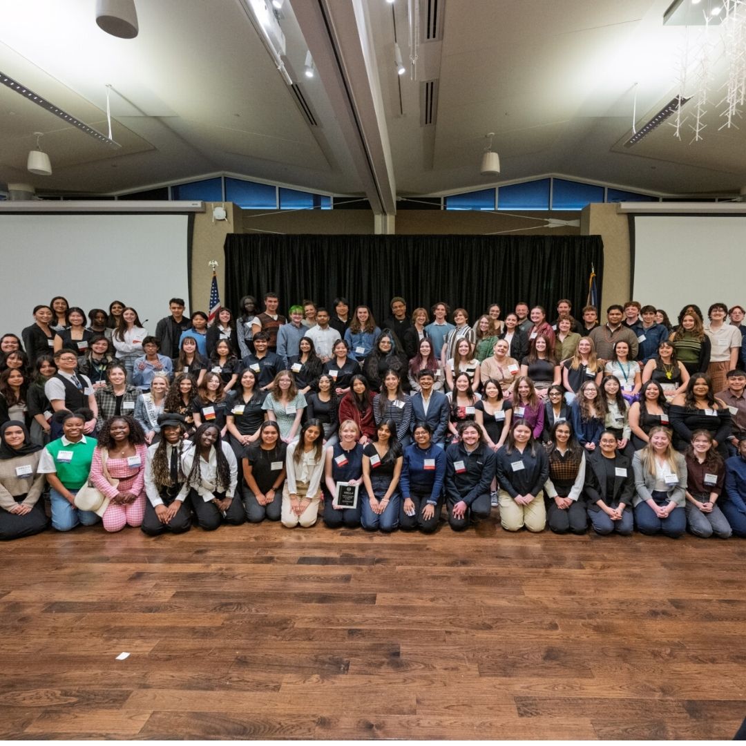 A large group of people pose for a picture at last year's MURALS symposium