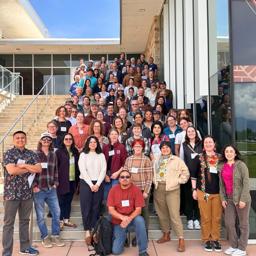 A group of 125 people stand on the stairs of the Lory Student Center