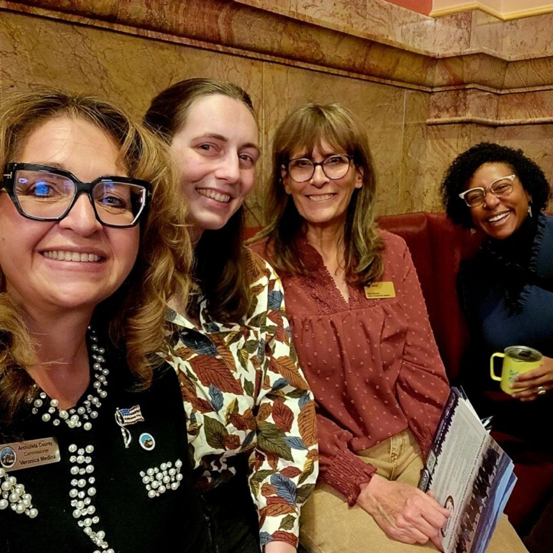 Four people sitting together at the legislative breakfast