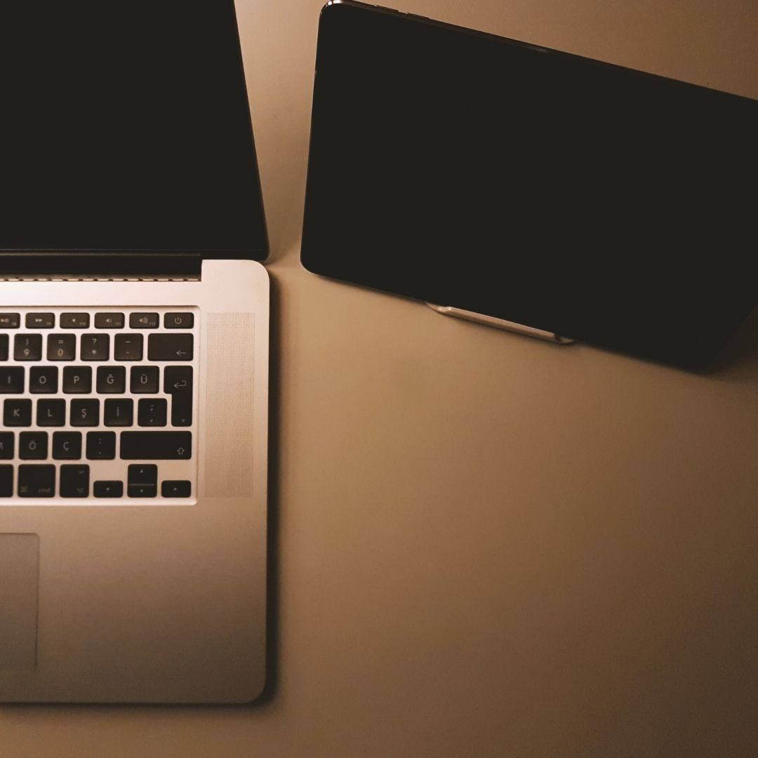 Photo of a computer and a tablet. 