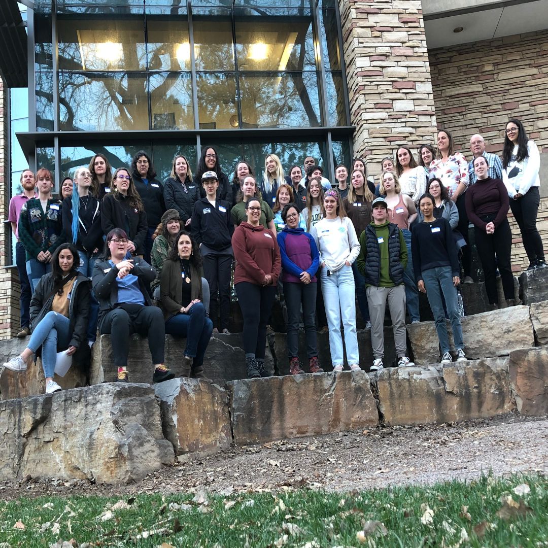 A group of people pose for a picture outside the Michael Smith Natural Resources Buillding